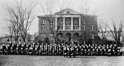 Navy personnnel pose in front of Weaver Hall.