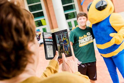 First-year student poses with the school mascot, Stinger.