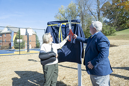 Theresa Malotte and E&H President Wells unveil signage for the Eric Scott '88 Memorial Court