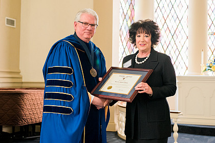 Marcia Gilliam is presented a college citation.