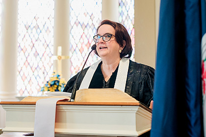 Chaplain Mary K. Briggs prays at Founders Day.