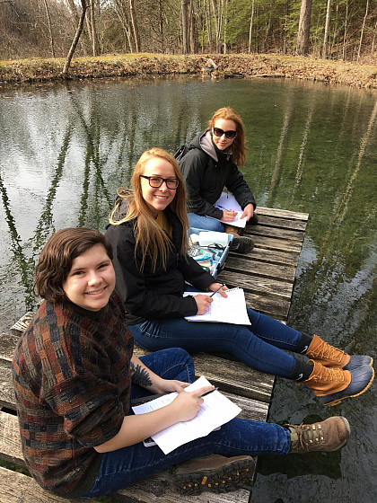 Students measuring water quality on the dock.