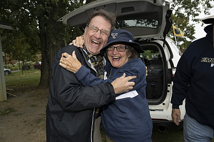 Two people hugging while posing to camera