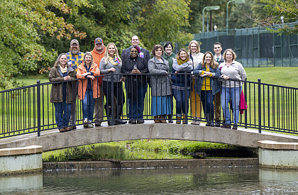 A group of alumni stand on the Duck Pond bridge