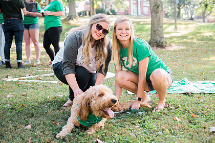 Zeta Phi sisters with a furry friend.
