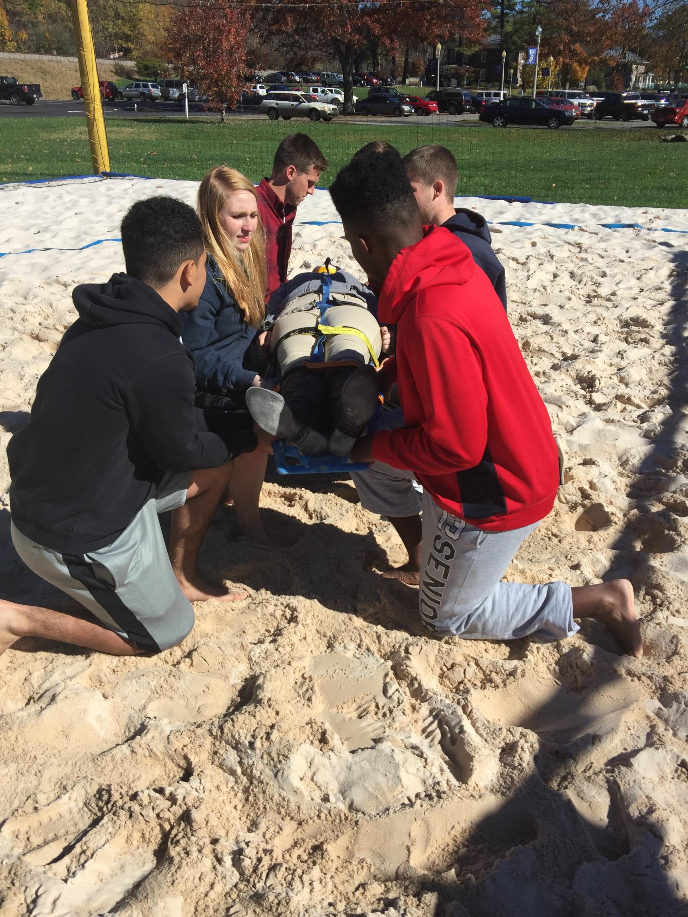 Students practicing spine boarding in challenging situations