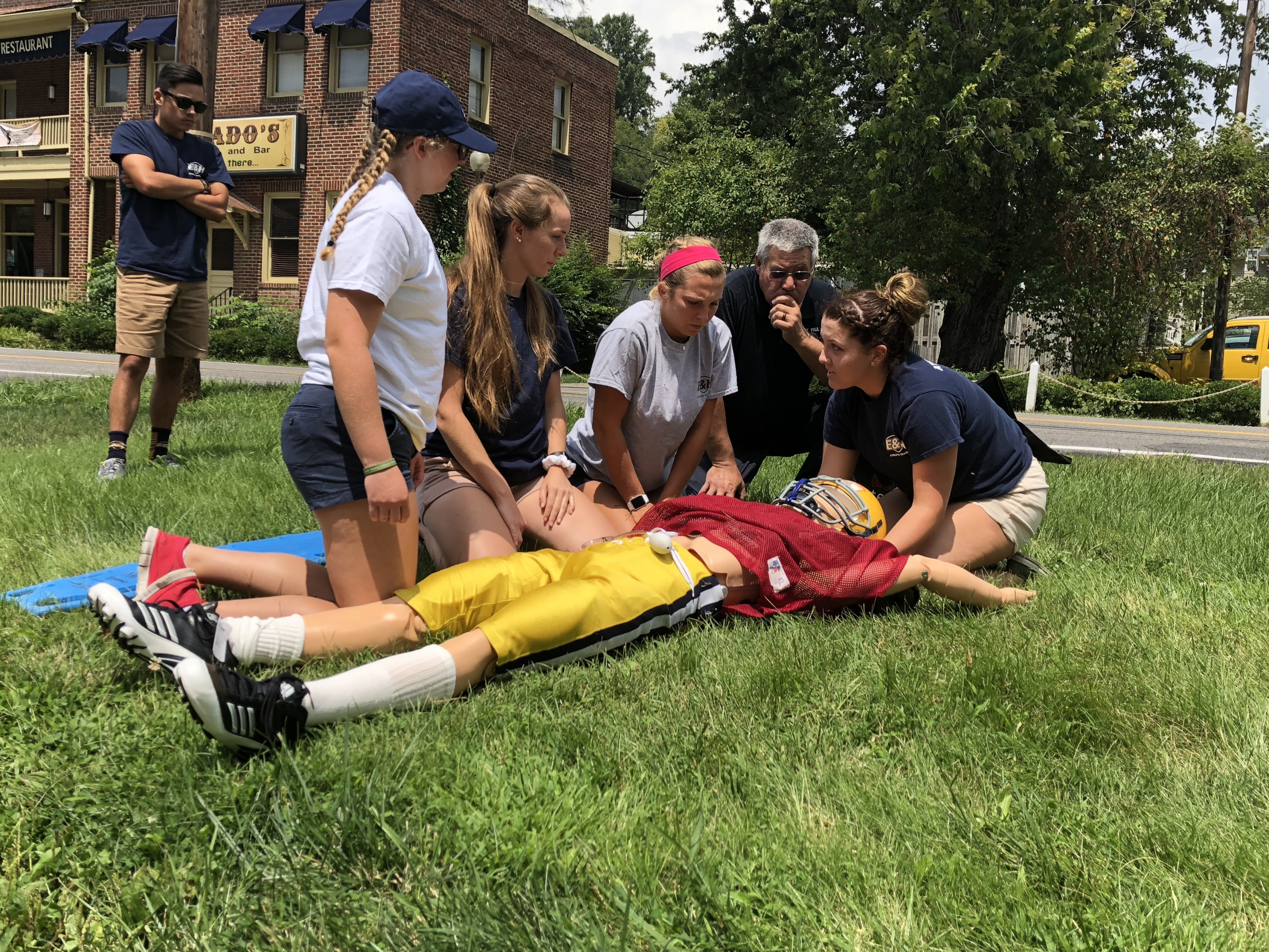 Students working with paramedics to learn best emergency care practices