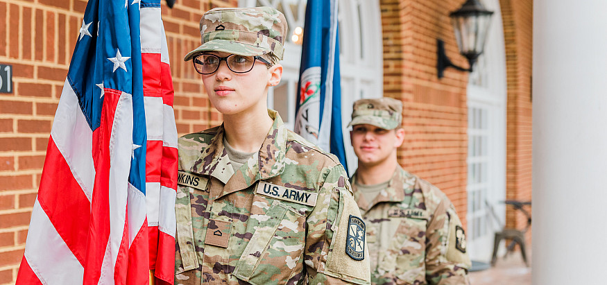 Two E&H ROTC students with American and Virginia flags