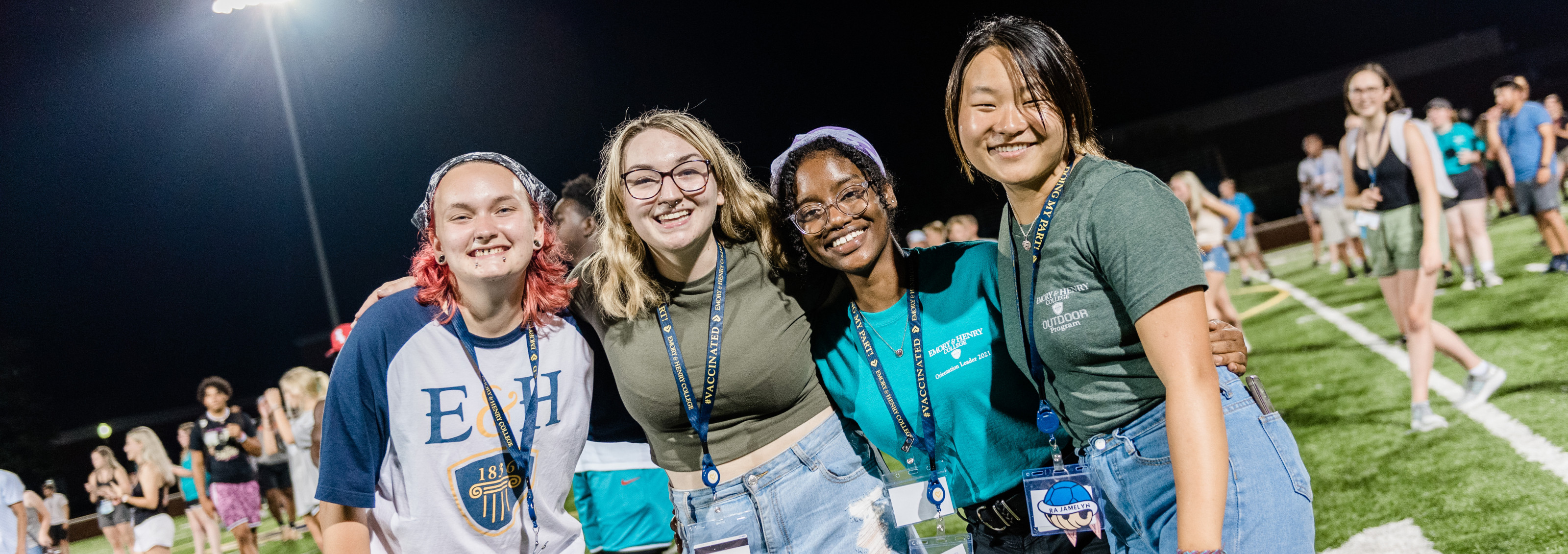 Students gather on the football field during Orientation activities.