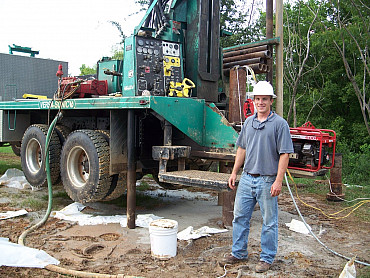 Alumnus Will McBryde installs a monitoring well in Alabama