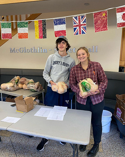 Students with sweet potatoes at the produce sale.