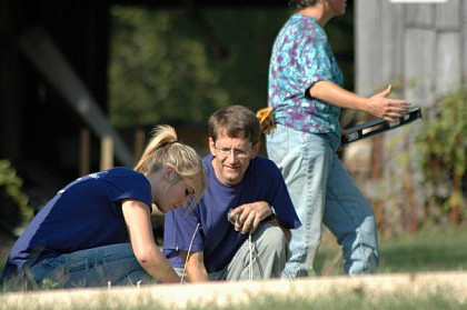 Prof. Ed Davis works with students in the garden.