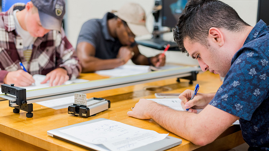 Students studying and working in the classroom.