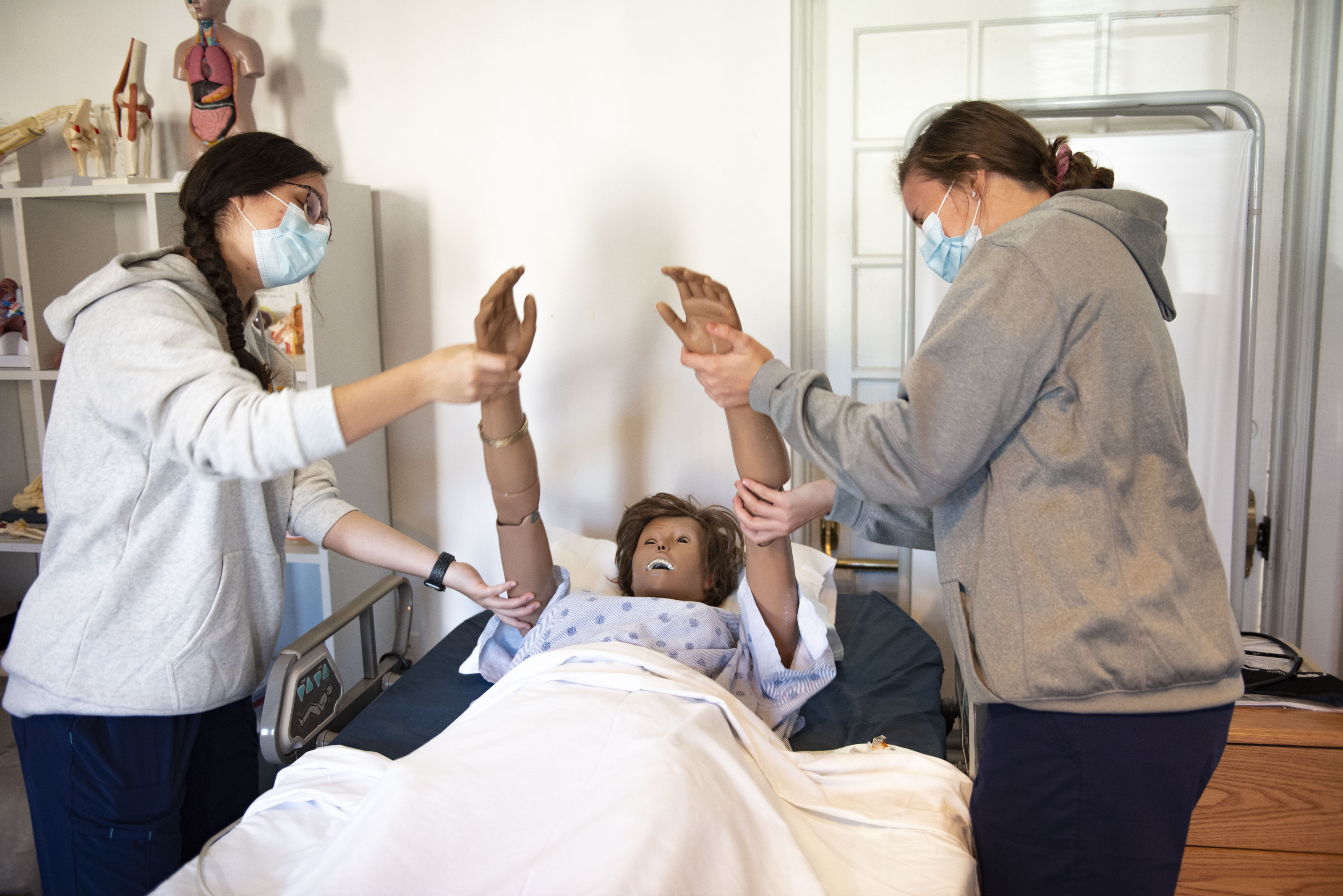 CNA Students working with a patient