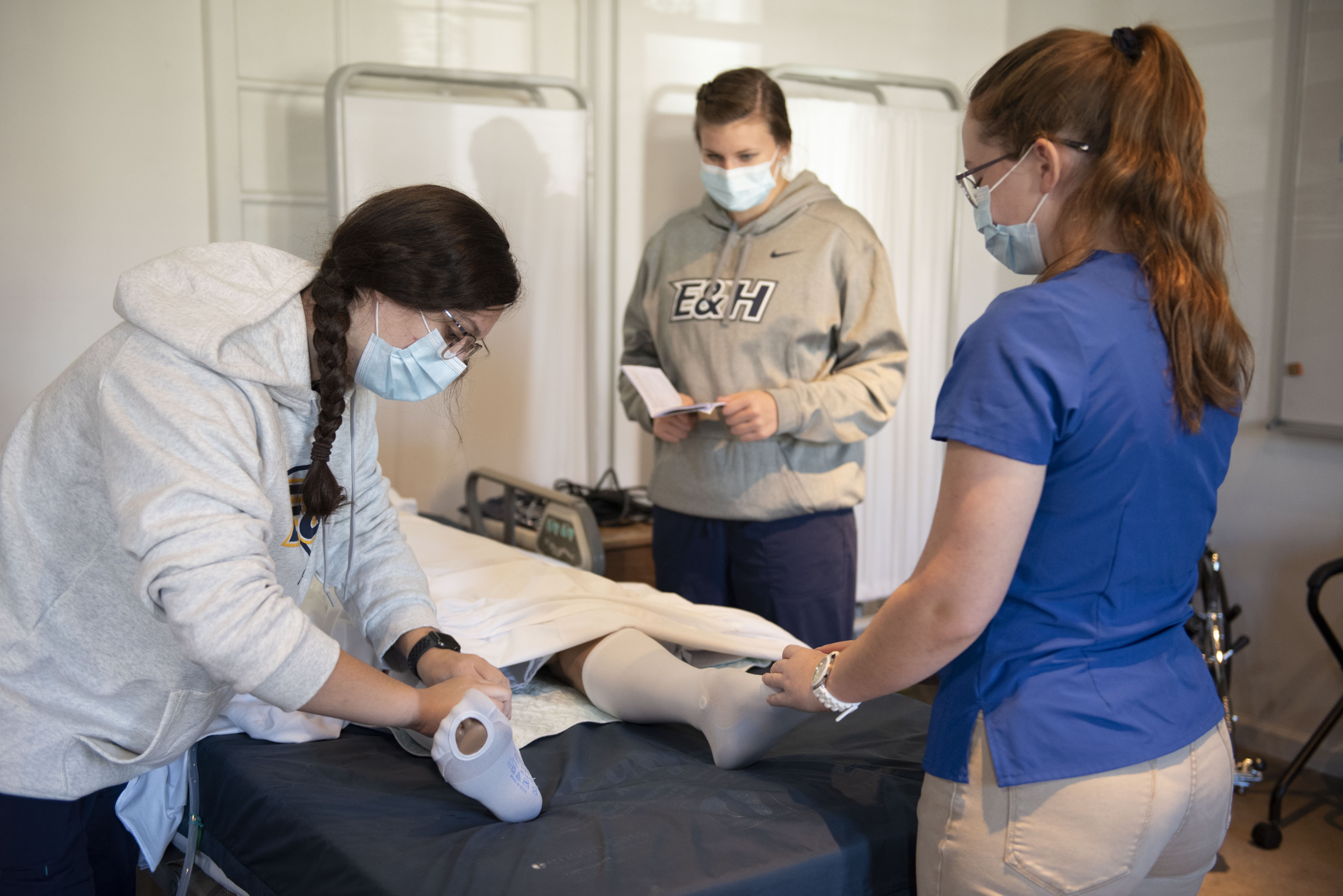 CNA Students applying compression stockings