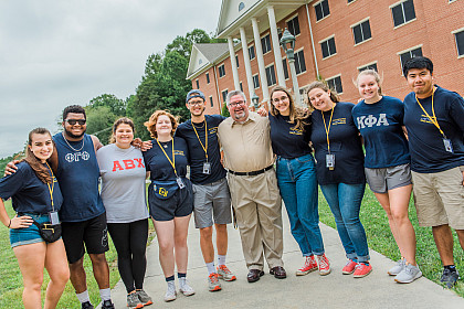 President John W. Wells poses with students during move-in day.