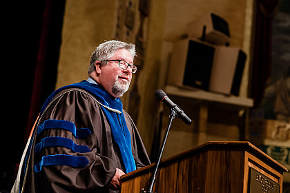 John Wells speaks at the School of Health Sciences commencement.