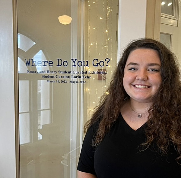 Lorin Zehr, '22, at the Where Do You Go? exhibit she curated.