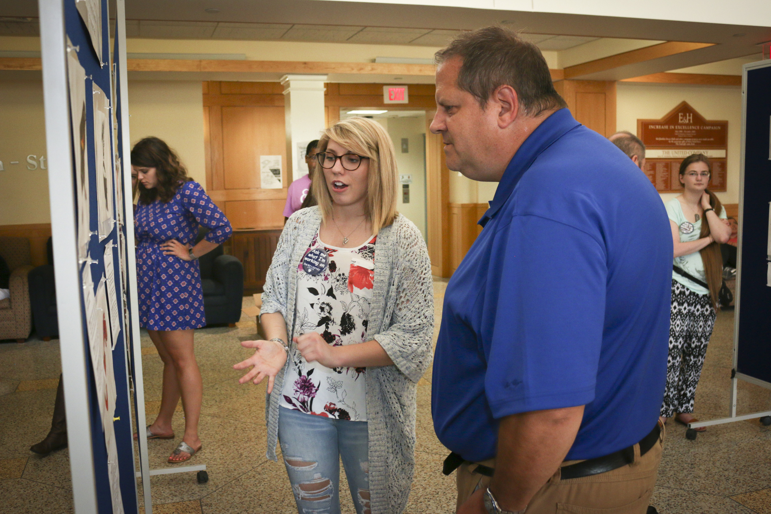 Prof. Chris Fielitz discusses a student's scientific illustrations on display at Ampersand Day 2017.