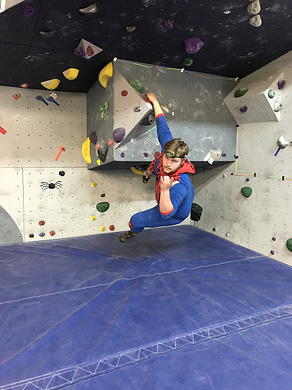 Climbing at the Outdoor Program Halloween Party dressed as Spiderman.