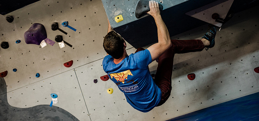 A student climbing the bouldering crag at the Center for Outdoor Studies