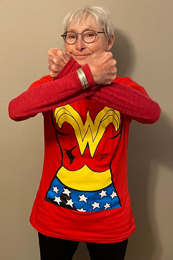 woman in wonder woman tshirt posing like Wonder Woman