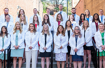 Students after the White Coat and Pinning Ceremony posing with their new coats.