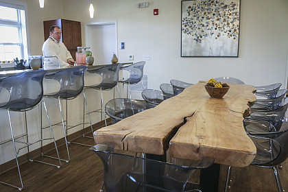 The kitchen of The Village Community Center features a dining table made from a tree that was located on the property.