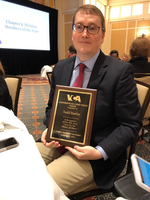 Todd Stanley and his award plaque for the Humanitarian and Caring Person Award.