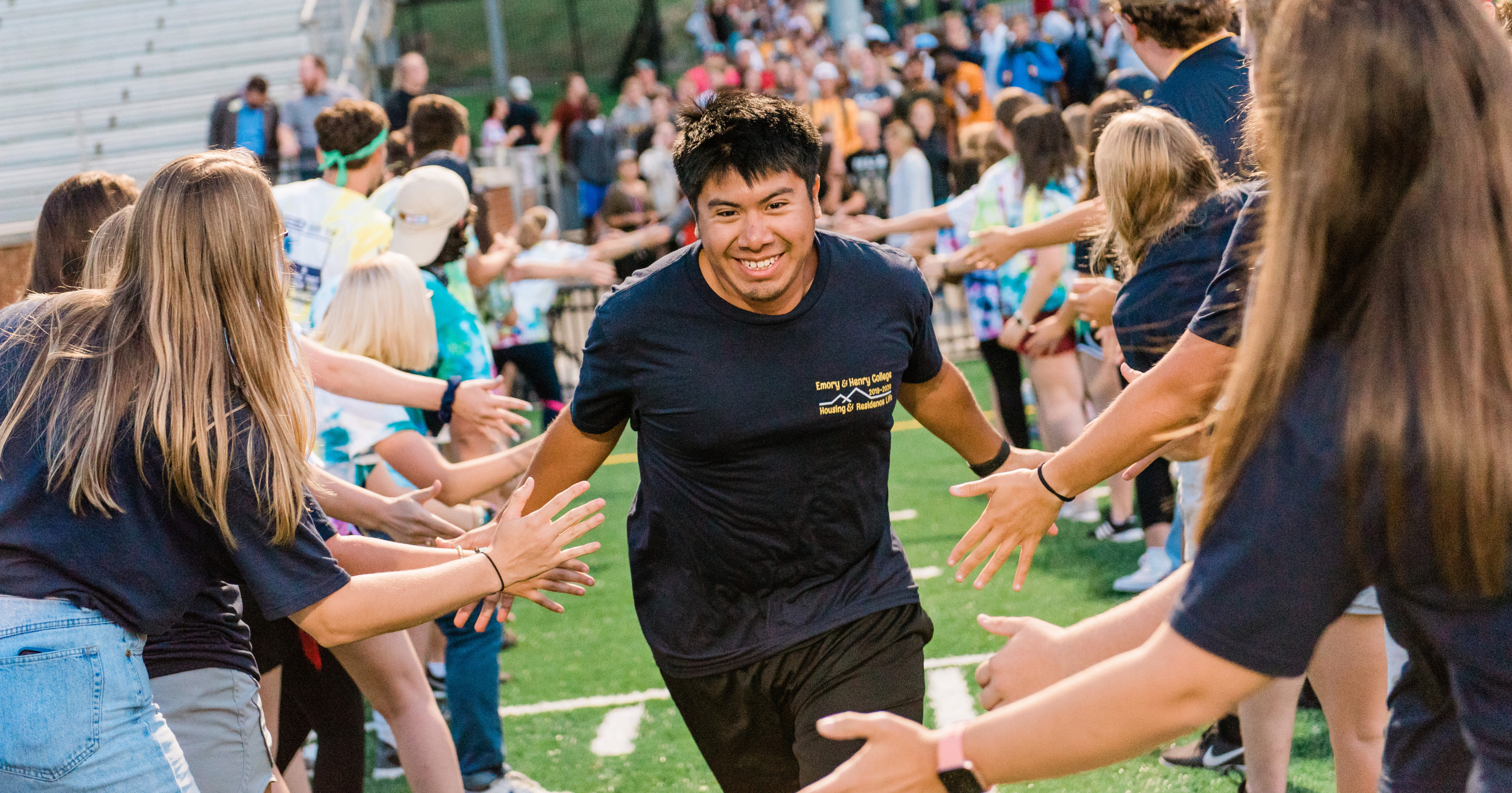 Student run giving high fives as a tradition at Play Fair.