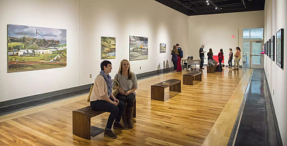 Students browse through the art exhibition housed in the McGlothlin Center for the Arts.