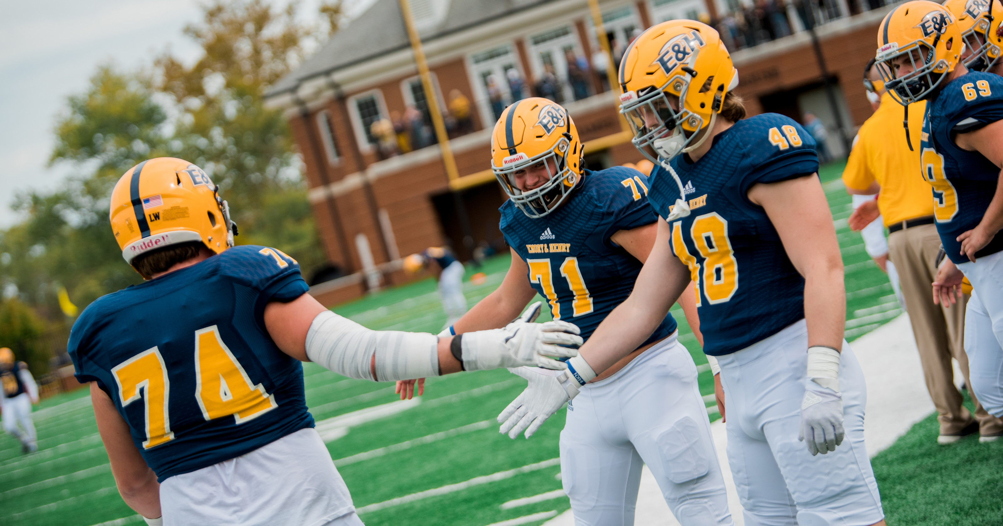 Football players high five.